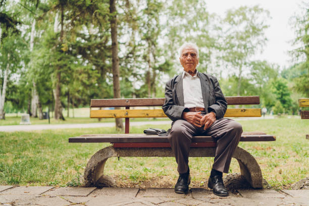 istock Senior man sitting on a park bench 1061407488