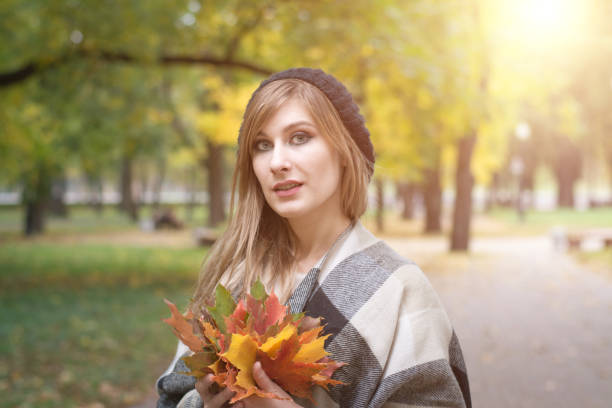istock Autumn woman on leaves background 1061408808