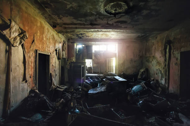 istock Dark creepy messy room with broken TV sets and other garbage 1061409704