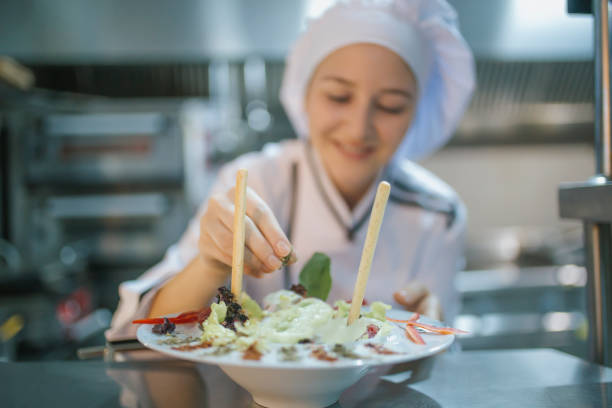 istock chef woman preparing salad 1061414046