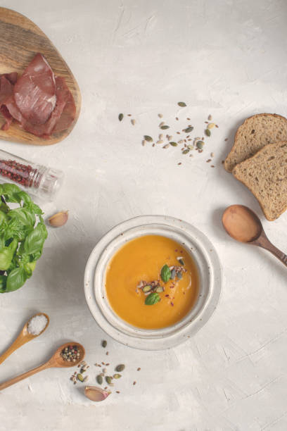 istock Pumpkin soup plate top view, gray background, copy space. 1061414212