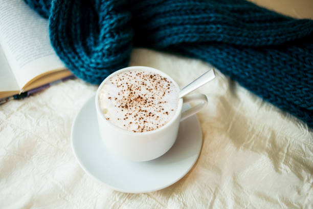 istock cup of tea with milk on a textile background with a knitted sweater and  needles 1061417068