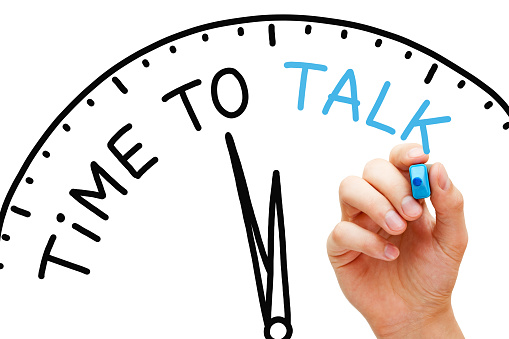 Hand writing Time to Talk concept with blue marker on transparent wipe board isolated on white.