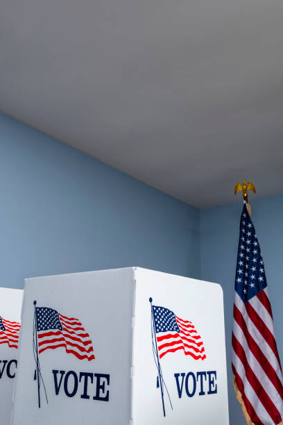 istock Empty voting booths with American flag at polling station 1061419322