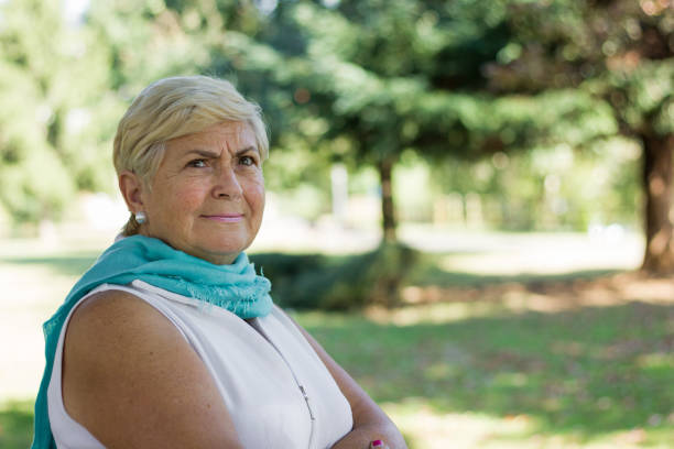 istock Pretty elder blonde woman with confused expression in the park 1061420342