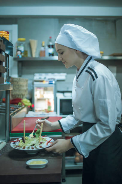 istock chef woman working in the kitchen 1061420392