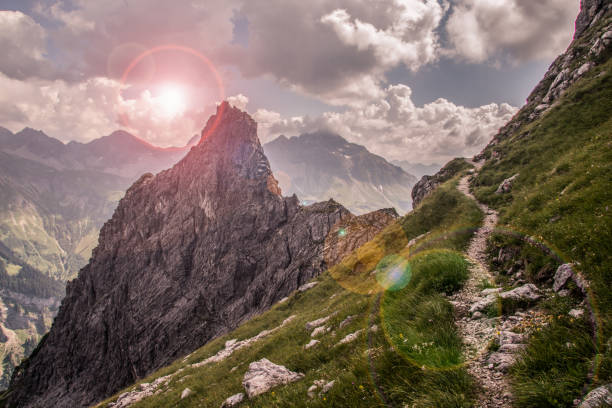 Sunset in the Mountains Narrow Mountain Path along a Steep Slope steep photos stock pictures, royalty-free photos & images