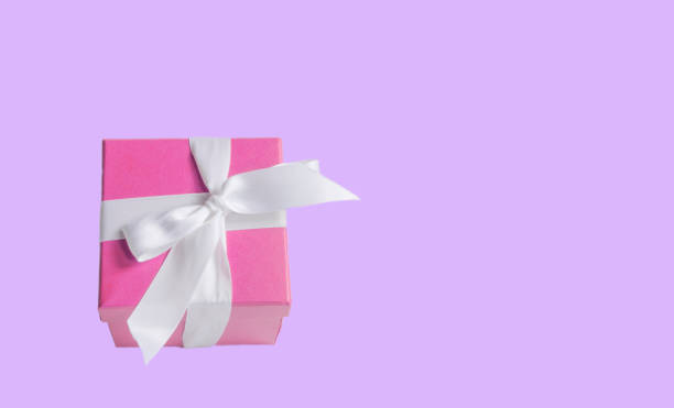 istock pink gift box on purple background 1061426918