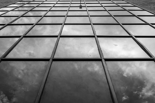 Photograph taken in Guadalajara, Jalisco, Mexico. Emphasizing a glass façade with the reflection of the clouds.