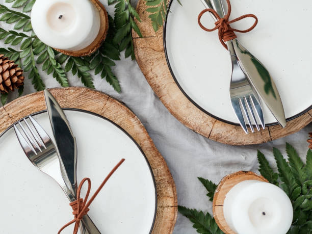 istock Festive table setting among winter decorations and white candles. Top view, flat lay. The concept of a Christmas or Thanksgiving family dinner. 1061439232