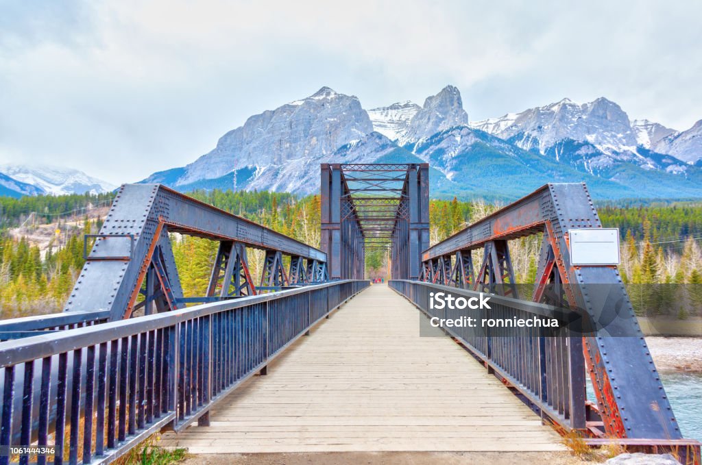 Canmore Engine Bridge Spur Line Trail Over Bow River Historic Canmore Engine Bridge is a truss bridge over the Bow River in the Canadian Rockies of Alberta. The bridge was built by the Canadian Pacific Railway in 1891 to serve a coal mine. The old rail spur line is now the Bow River hiking loop trail in Canmore. Canmore Stock Photo