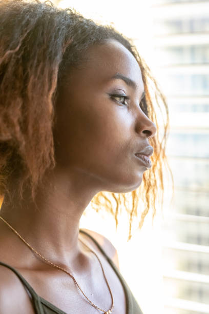 istock Serious young beautiful black woman looking through a window 1061446864