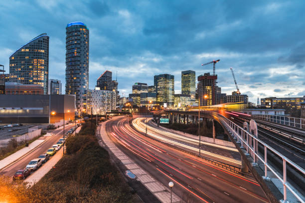 vista urbana con rascacielos, trenes borrosa y senderos de luz - uk night skyline london england fotografías e imágenes de stock