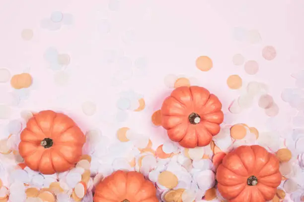 Little decorative pumpkins with confetti. Autumn and Halloween concept.