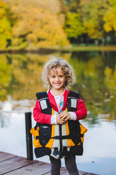 istock Cute blond curly girl in a life-jacket 1061455190