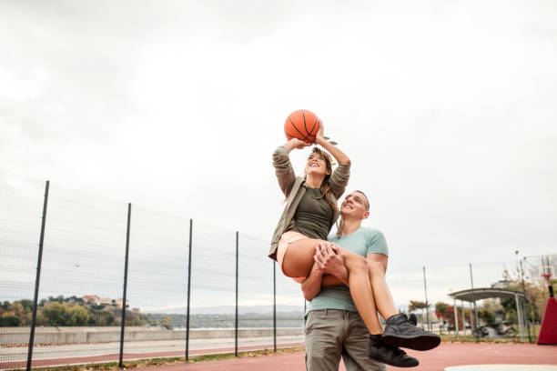 istock A disabled man helping girlfriend to dunk and score 1061457678