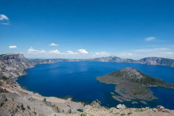 Wide angle view of Crater Lake National Park in Oregon, on sunny clear summer day.  Wizard Island in photo