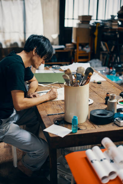 istock Mature male artist sketching ideas in his studio 1061468556