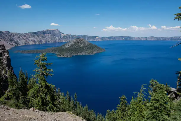 Wide angle view of Crater Lake National Park in Oregon, on sunny clear summer day.  Wizard Island in photo