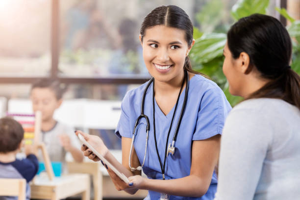 istock Young pediatrician enjoys conversation with parent 1061473676