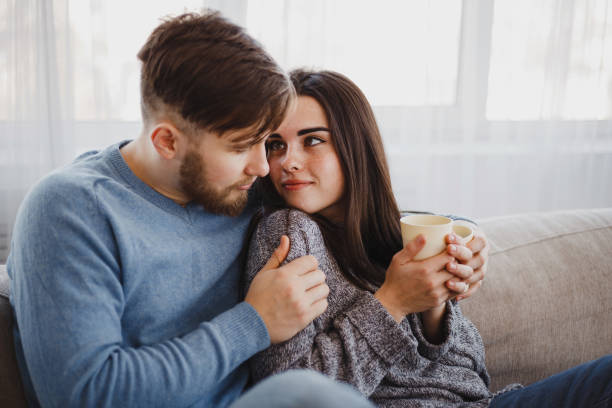 istock Couple drinking coffee in living room 1061477220
