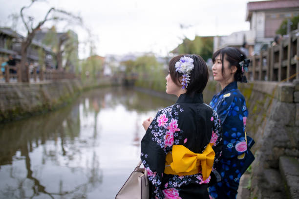 istock Young women in yukata looking at river 1061479408