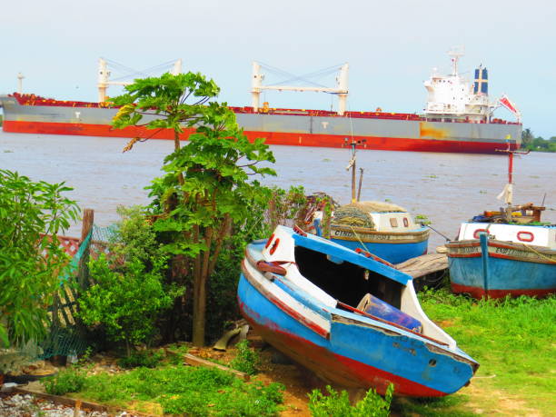 istock Small boats and industrial boat on the river. 1061484096