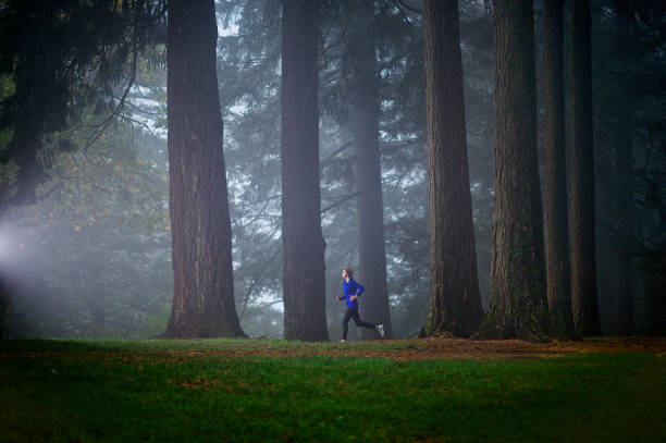 istock Forest Fog Female Runner 1061488970