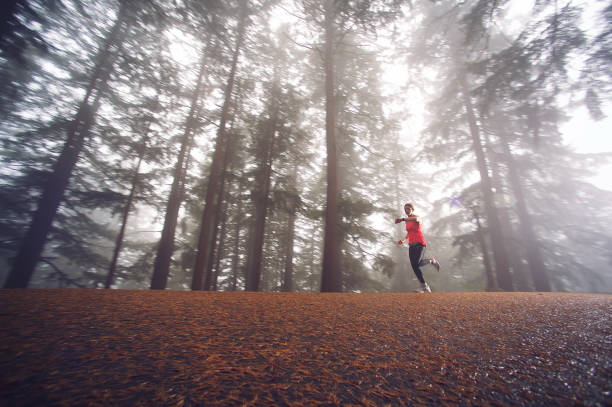 istock Full out female fog forest time check 1061489098