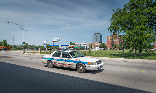 Chicago, Illinois, USA. 08th August 2013. Ford police car driving on the streets of Chicago. Patrol during day with a prisioner on the back seat.