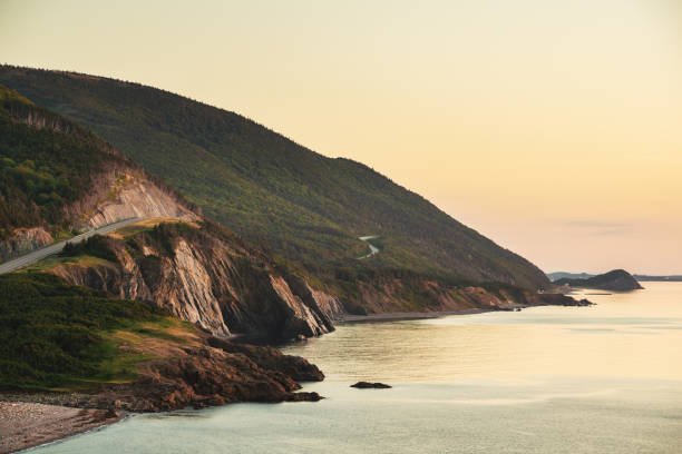 Coastline cliff sunset A view of the Cabot Trail on Cape Breton Island, Nova Scotia taken at sunset. cabot trail stock pictures, royalty-free photos & images