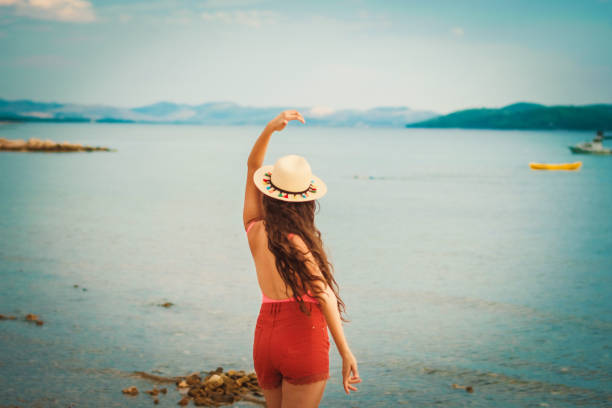 istock Excited Smiling Female Dancing on Summer Beach Sand 1061497128