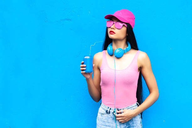 istock Woman holding blue can and standing on blue backgroud 1061501826