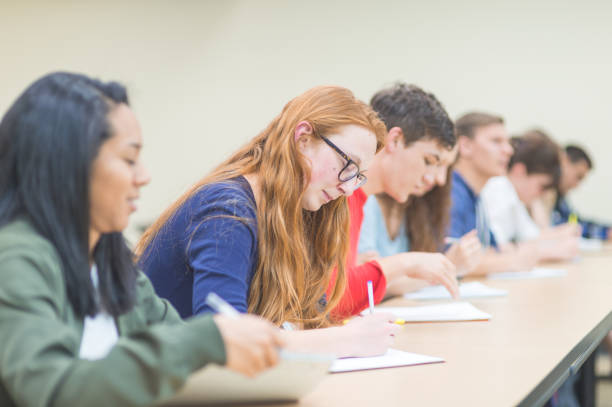 istock College students studying at desks in a lecture hall 1061502294