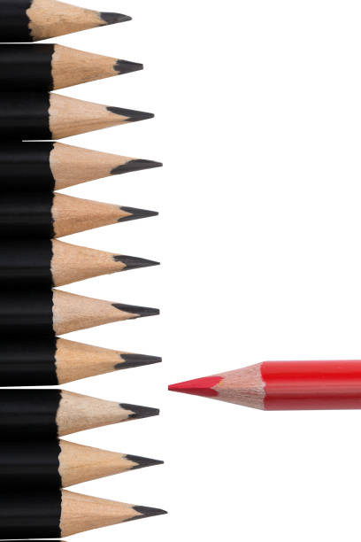 istock Red pencil among black ones on white background 1061502414