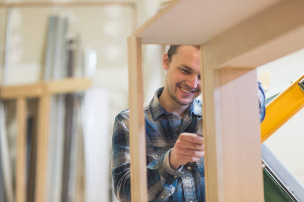istock Closeup of a woodworker putting putty on a cabinet 1061509352