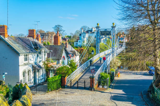 View of residential houses alongside river Dee in Chester, England View of residential houses alongside river Dee in Chester, England chester england stock pictures, royalty-free photos & images