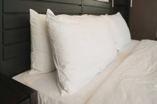 istock white pillow on bed with blanket in bedroom, closeup 1061518564