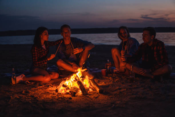 istock young friends have picnic with bonfire on the beach 1061520394