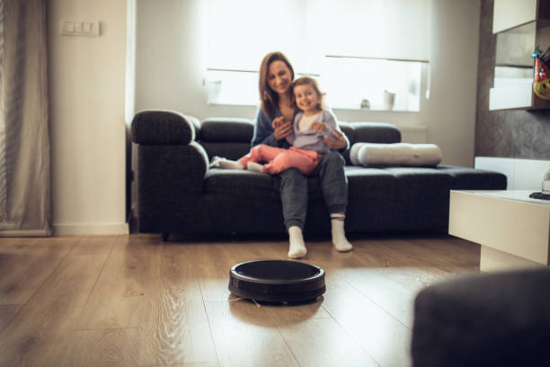 istock Family watching vacuum cleaner cleaning 1061543368