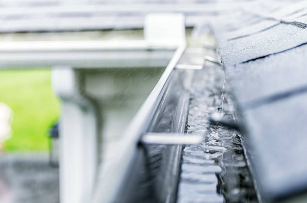 istock Close-Up Rain Storm Water Draining Into Roof Edge Gutter 1061551992