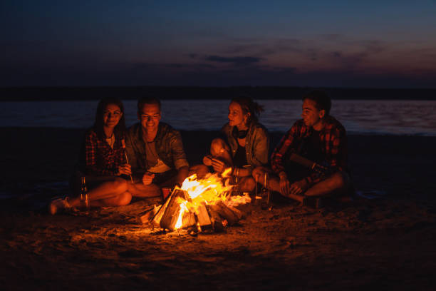 istock young friends have picnic with bonfire on the beach 1061561066