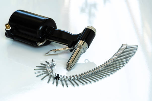 Rivet Gun and Rivets , Pneumatic rivet gun and Pop rivets on a white background.