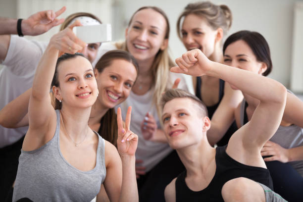 istock Sportive athletic millennial people making selfie indoors 1061567788
