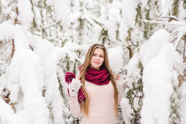 istock Smiling young woman outdoors in a winter forest 1061572610