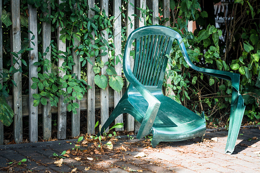 broken green garden chair