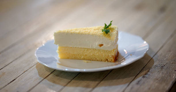 istock Homemade lemon cheese cake with cheese powder on light timber table 1061582120