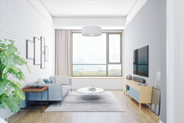 Furniture in a modern style, a large TV screen in the modern living room with panoramic windows. Comfortable living space.