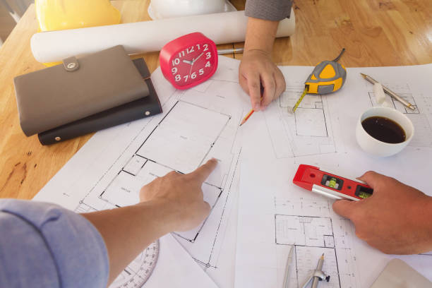 istock Engineer and Architect concept, Engineer Architects and real estate agent office team working with blueprints 1061600128