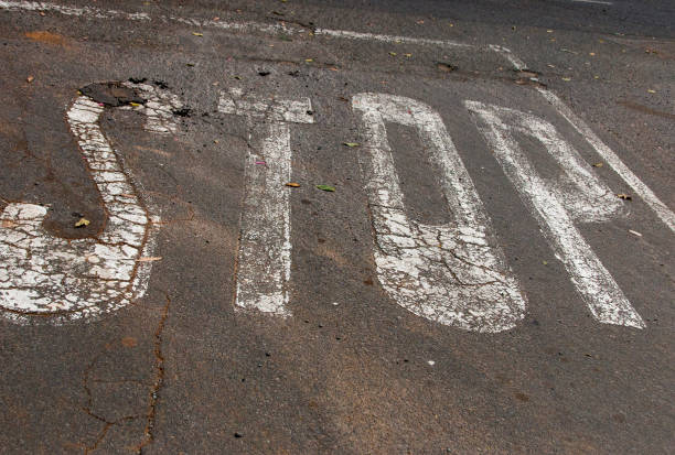 istock slighty woren painted white stop sign 1061609164